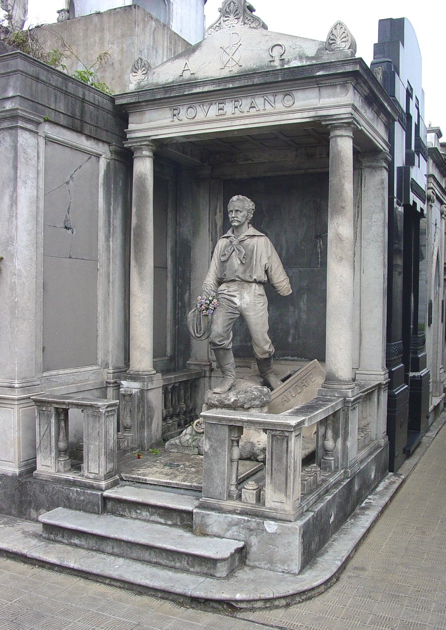 ArgentinaBuenosAires-Cemetery-GraveWithStatueOfManWithFlowers--2707