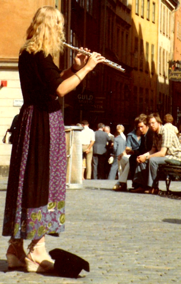 Stockholm old city woman plays flute