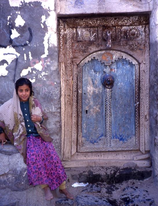 girl beside blue door